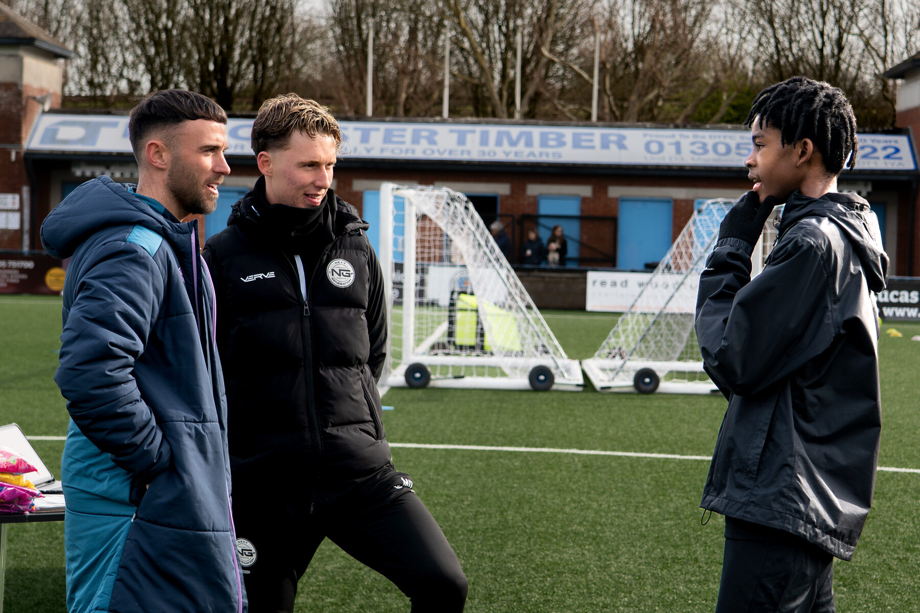 Coaches and players talking after a session