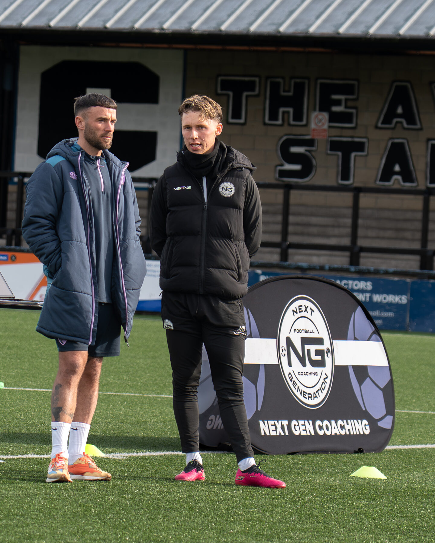 NGFC coaches with the club banner at the stadium