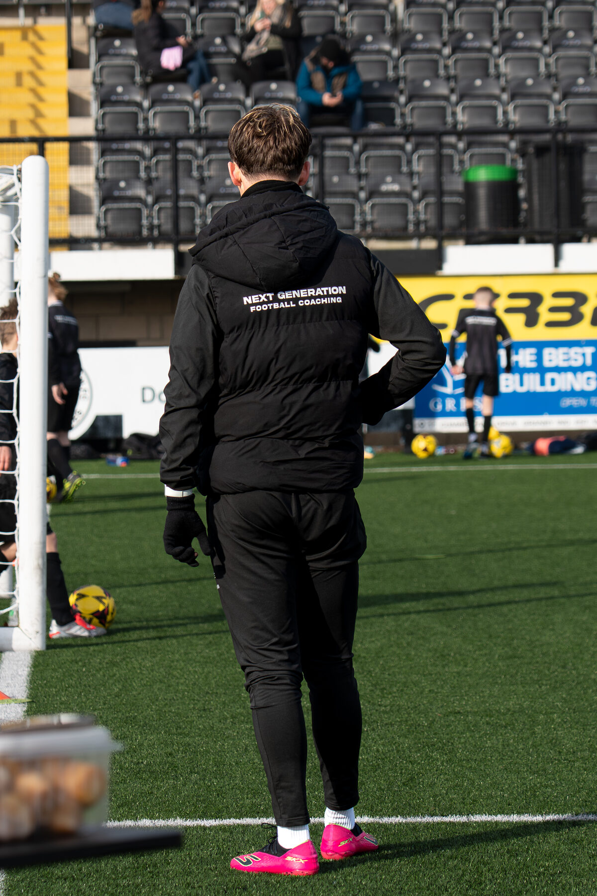NGFC coach organising a session inside a football stadium