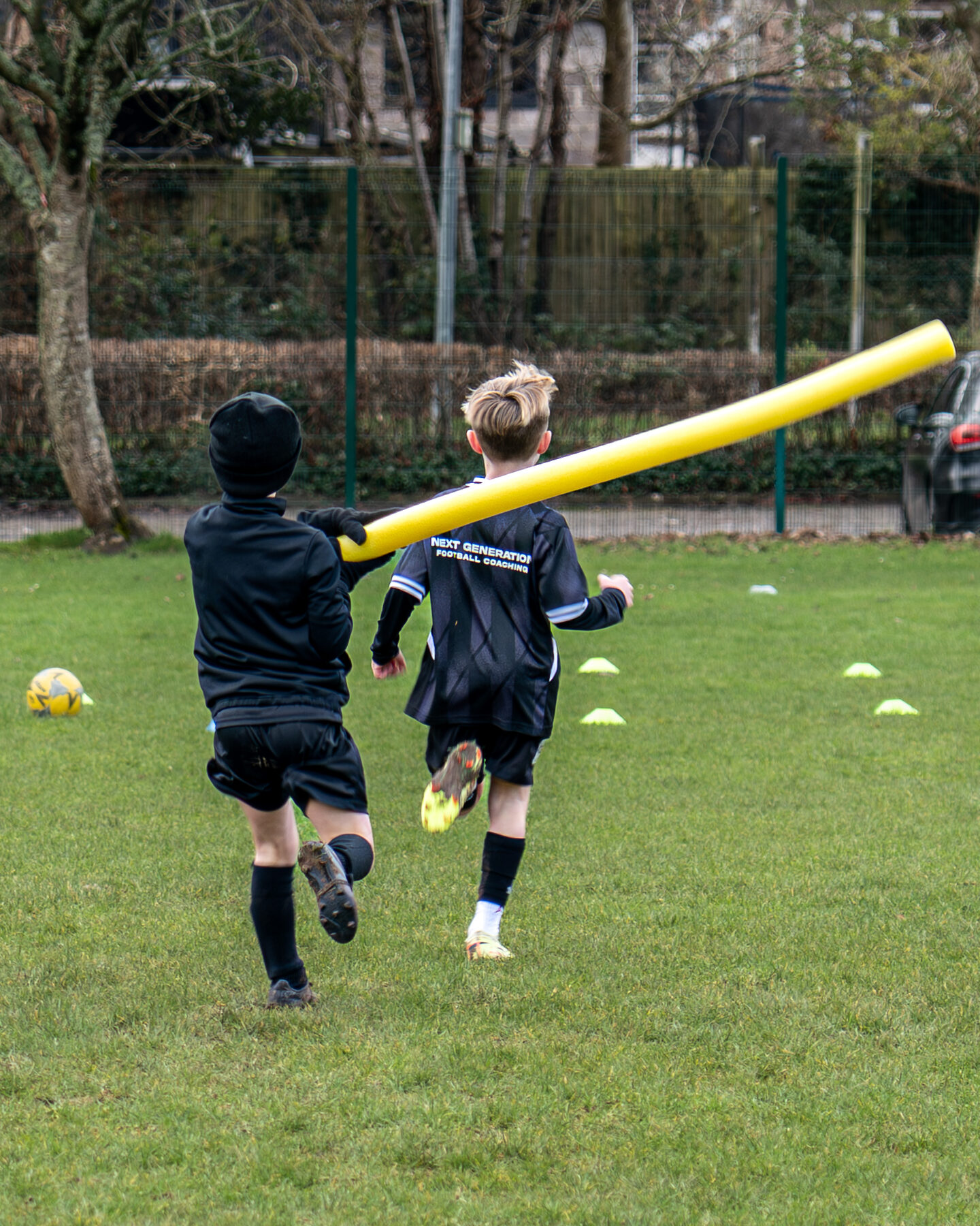 Boy sprinting through a cone channel in an NGFC agility drill