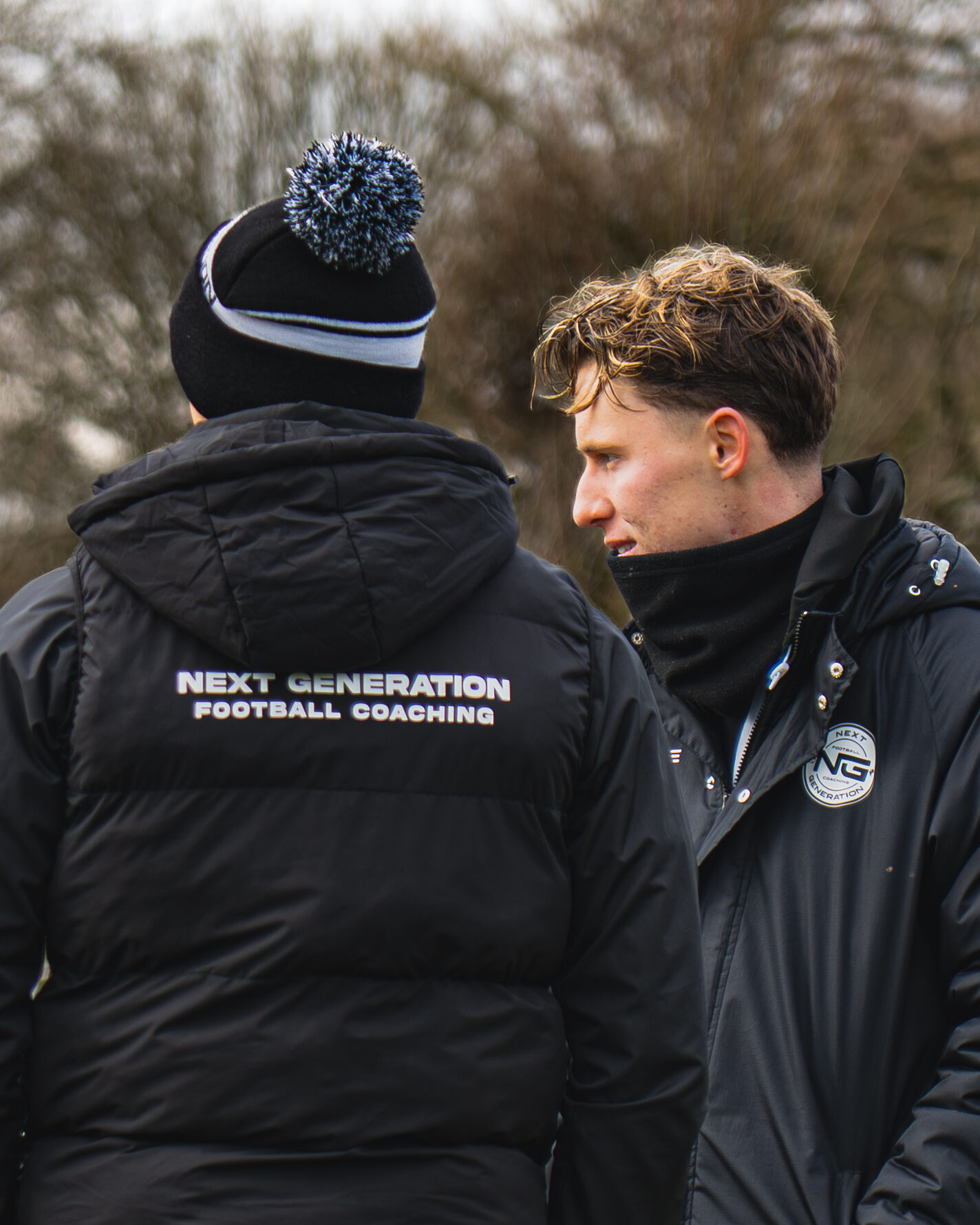Coach and young player talking tactics on the touchline