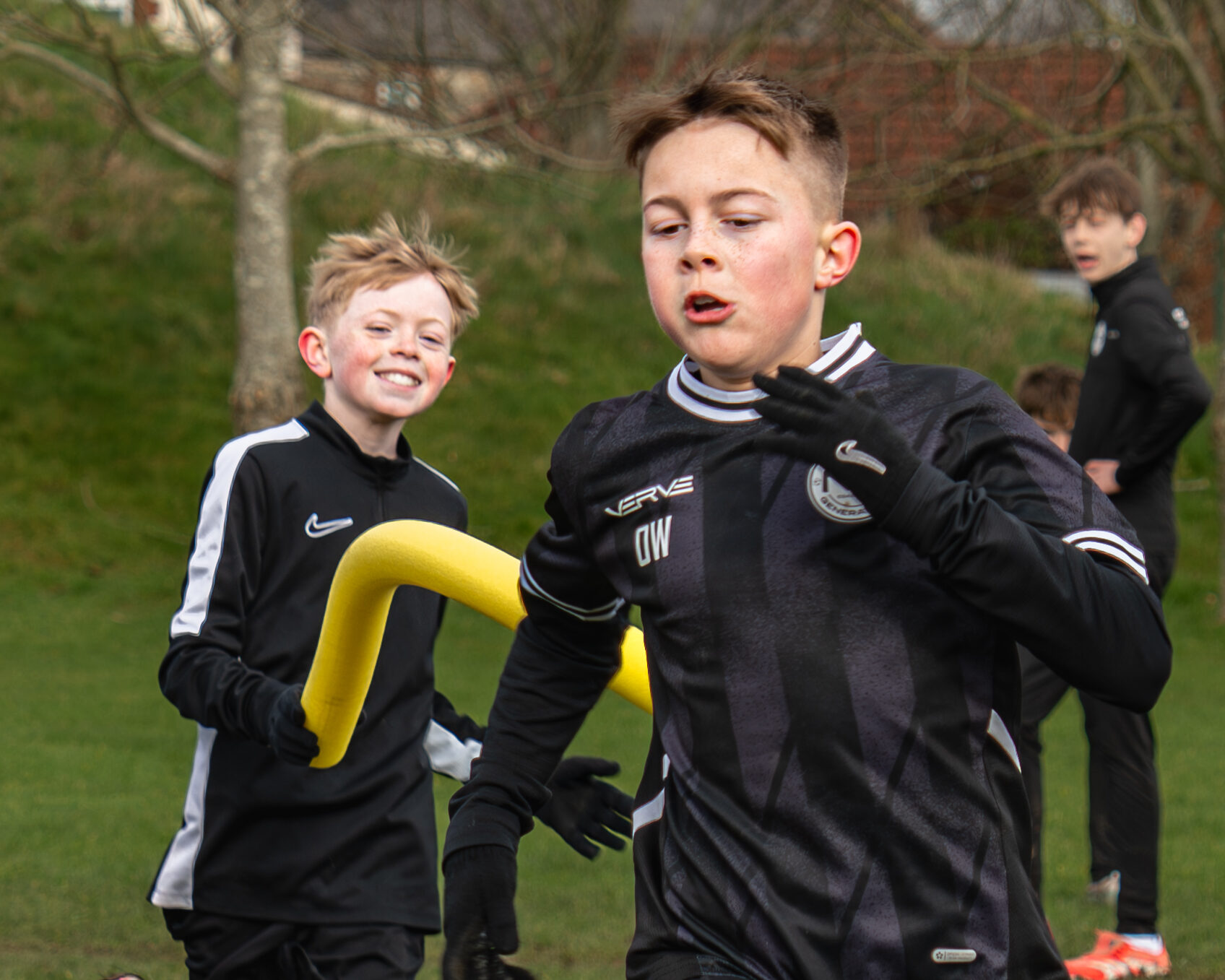 Young players working through a hurdle and cone circuit