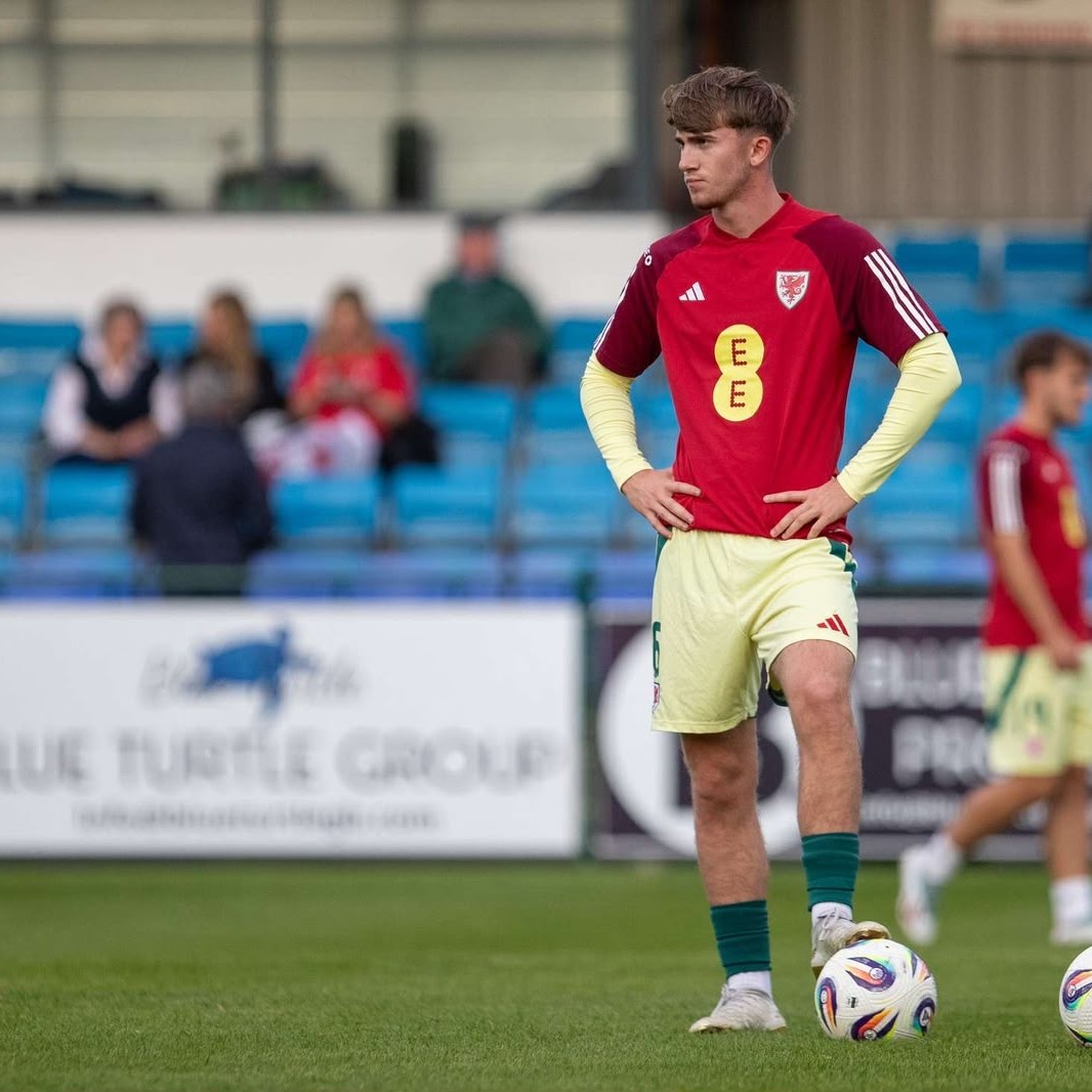 Josh Salmon in a Wales international kit on the pitch