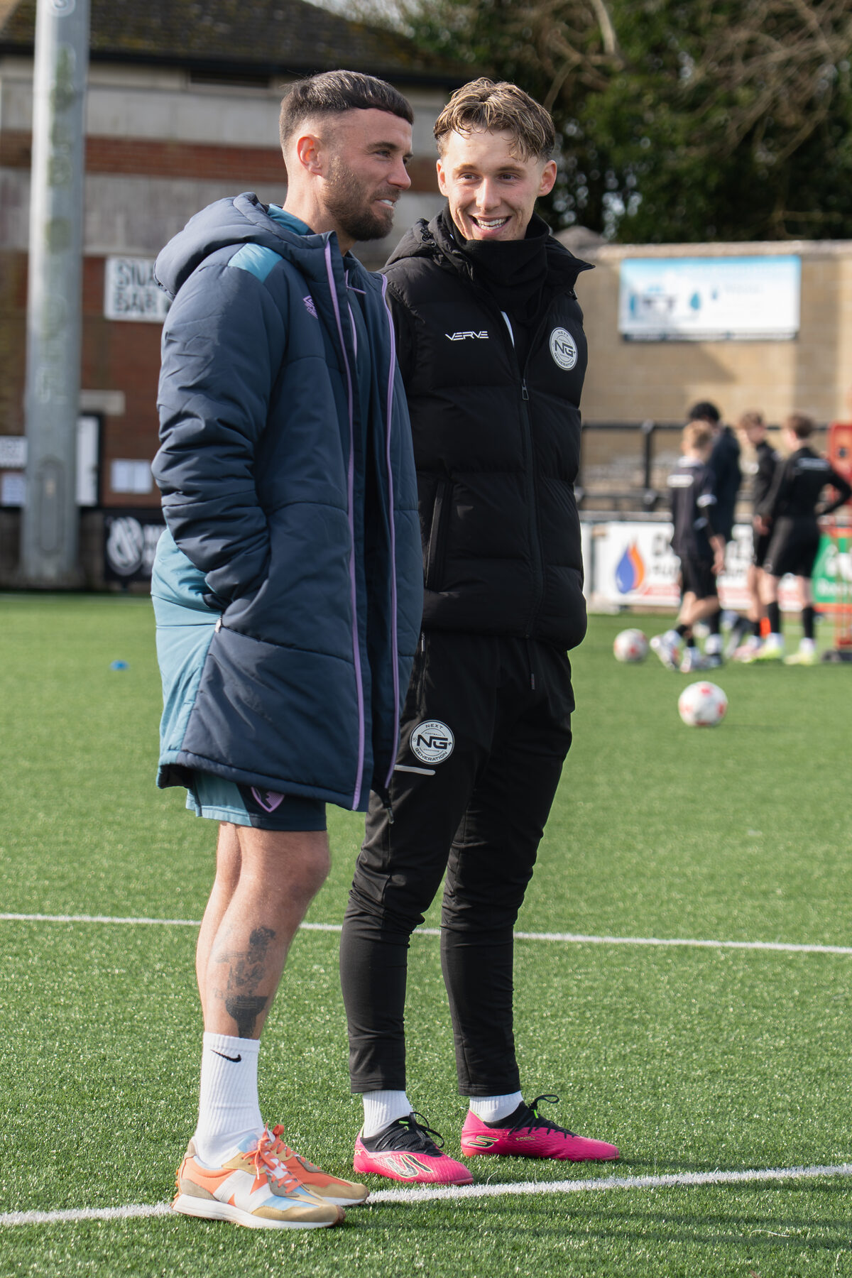 Coach and player working together on the stadium pitch
