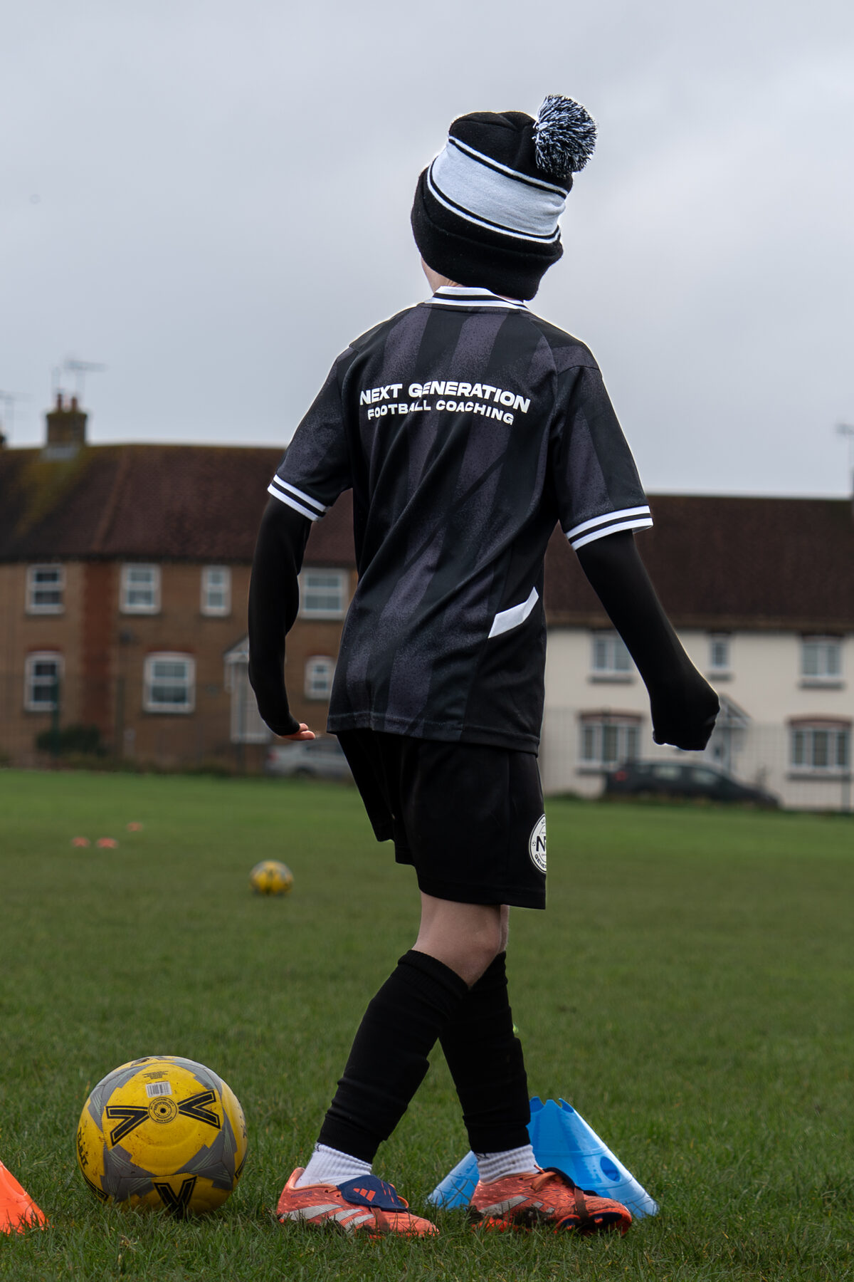 Young NGFC player standing over the ball in a bobble hat