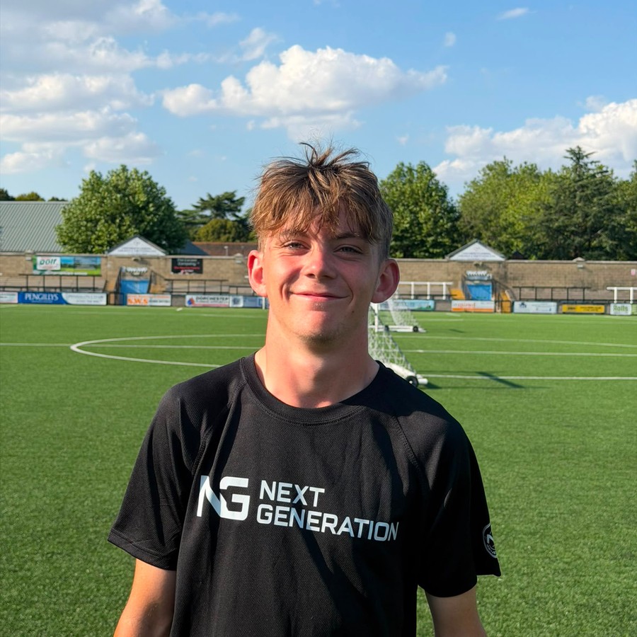 Alfie Robinson in a black Next Generation shirt on the pitch